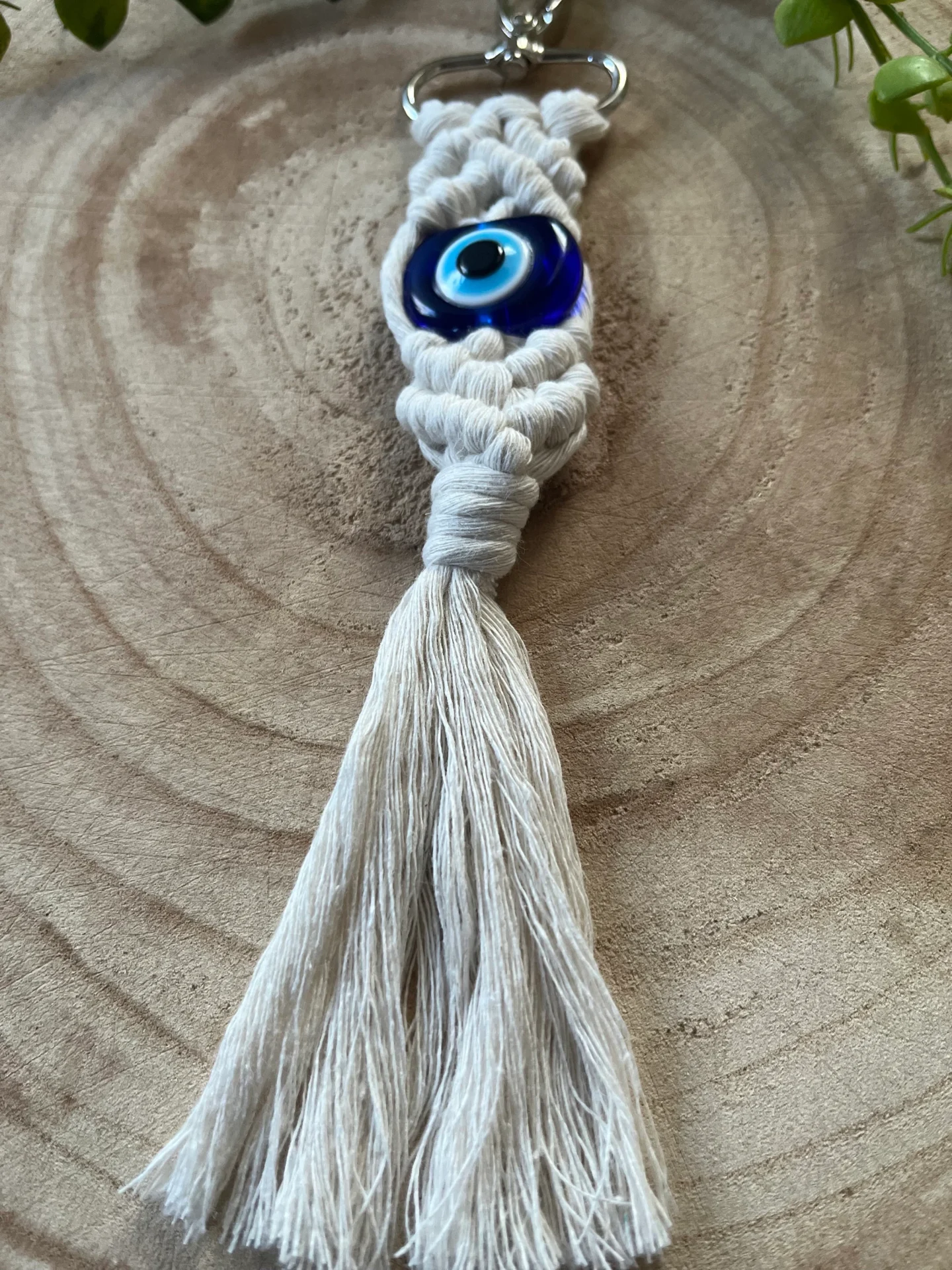 Evil eye bead macrame keychain made with recycled cotton and a resin bead, on a metal lobster clasp