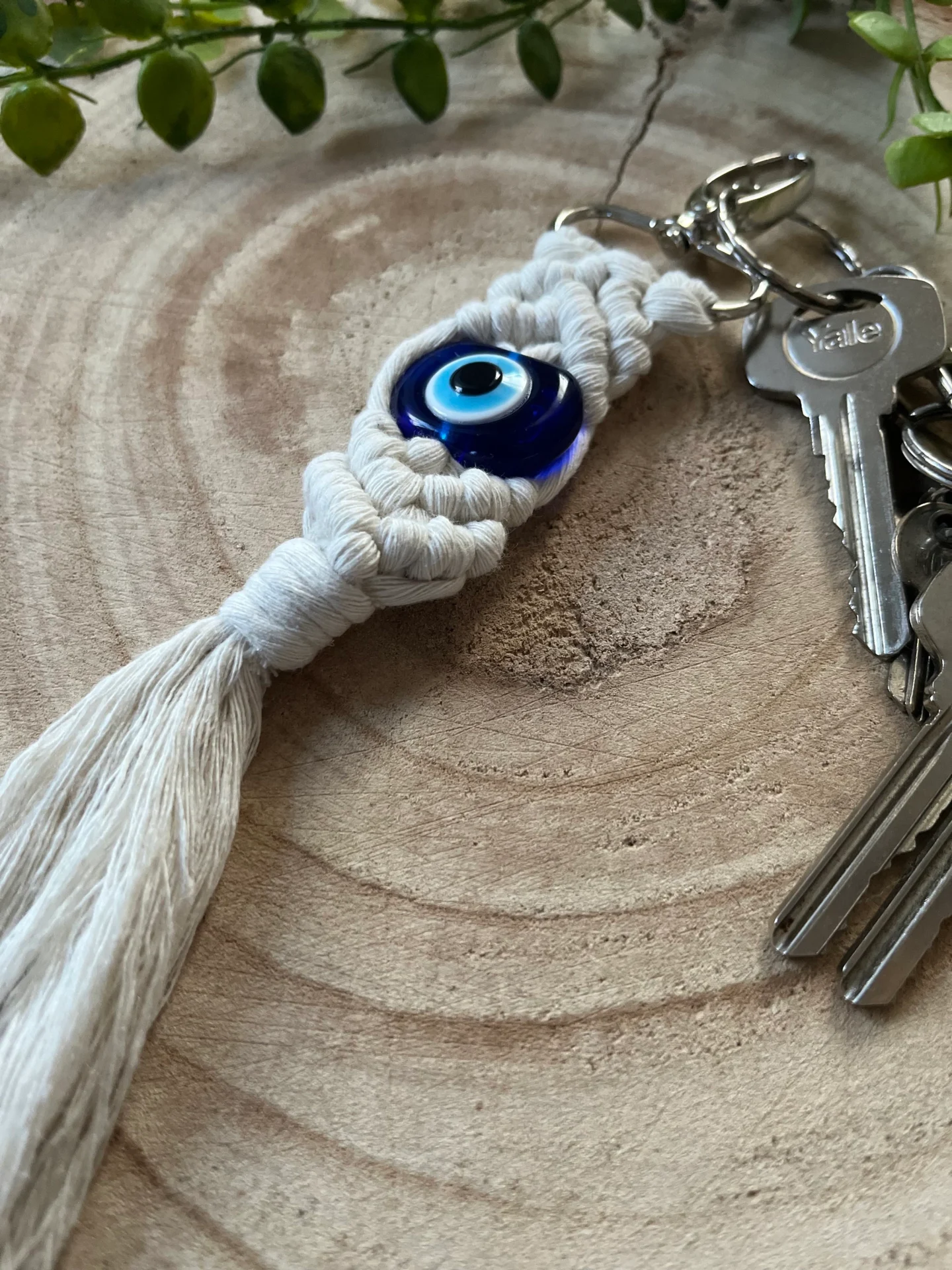 Evil eye bead macrame keychain made with recycled cotton and a resin bead, on a metal lobster clasp