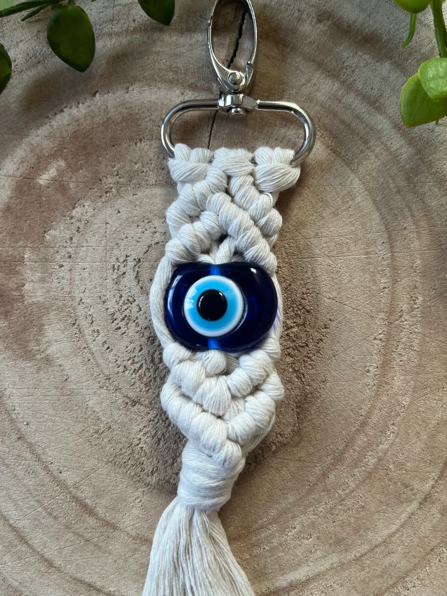 Evil eye bead macrame keychain made with recycled cotton and a resin bead, on a metal lobster clasp