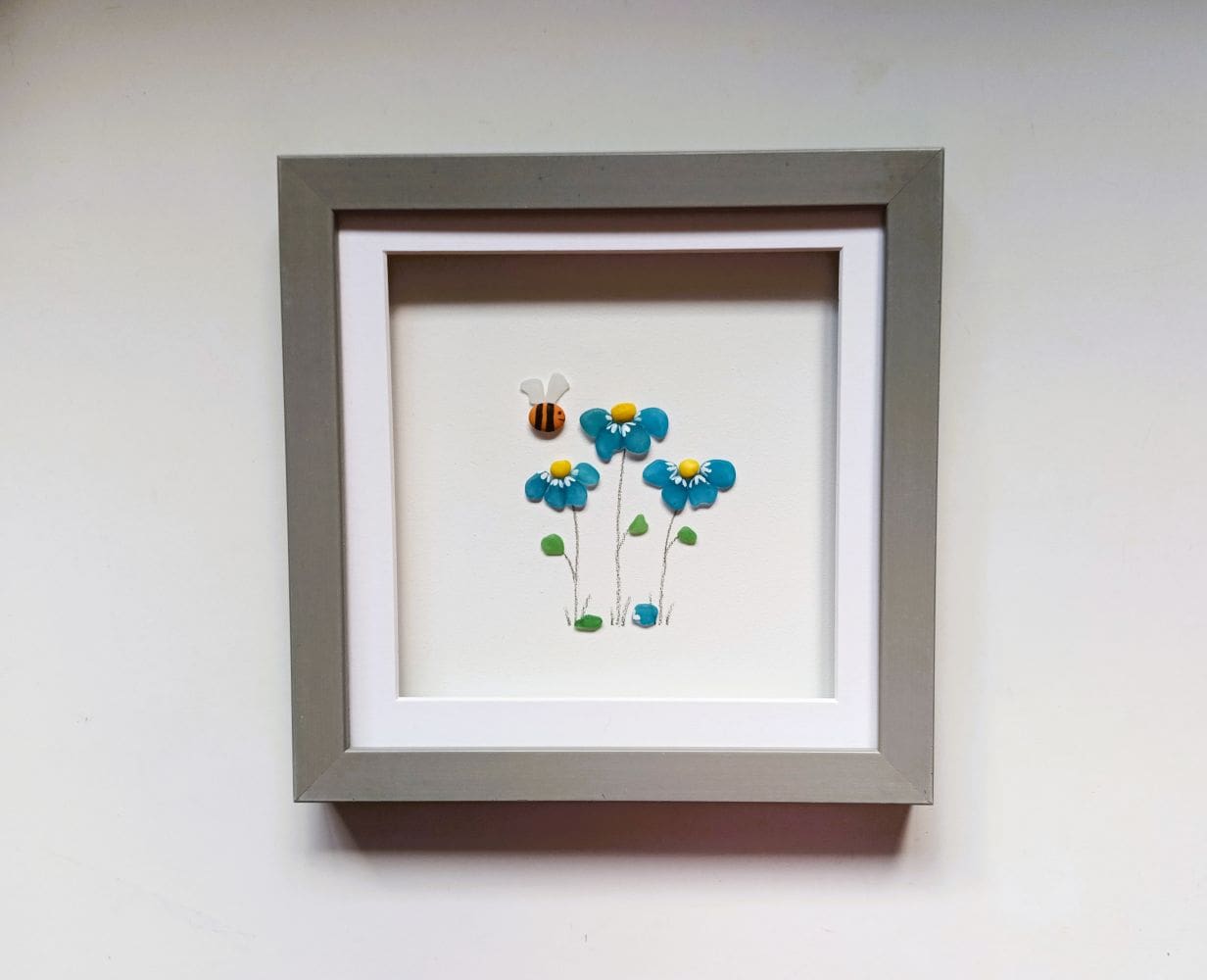 framed picture of three forget me not flowers made from Cornish sea glass