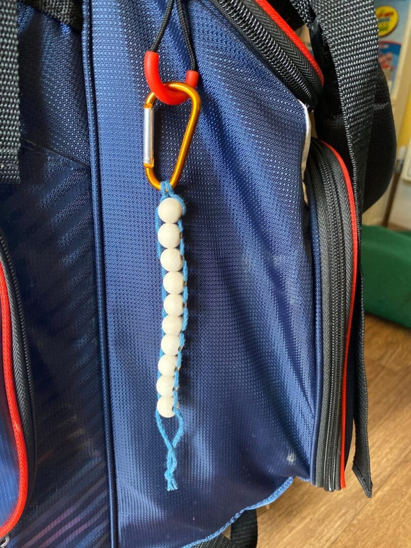 Golf Stroke counter made with recycled cotton, and wooden beads on a carabiner clip