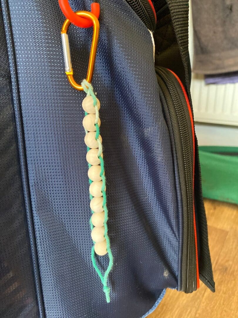 Golf Stroke counter made with recycled cotton, and wooden beads on a carabiner clip