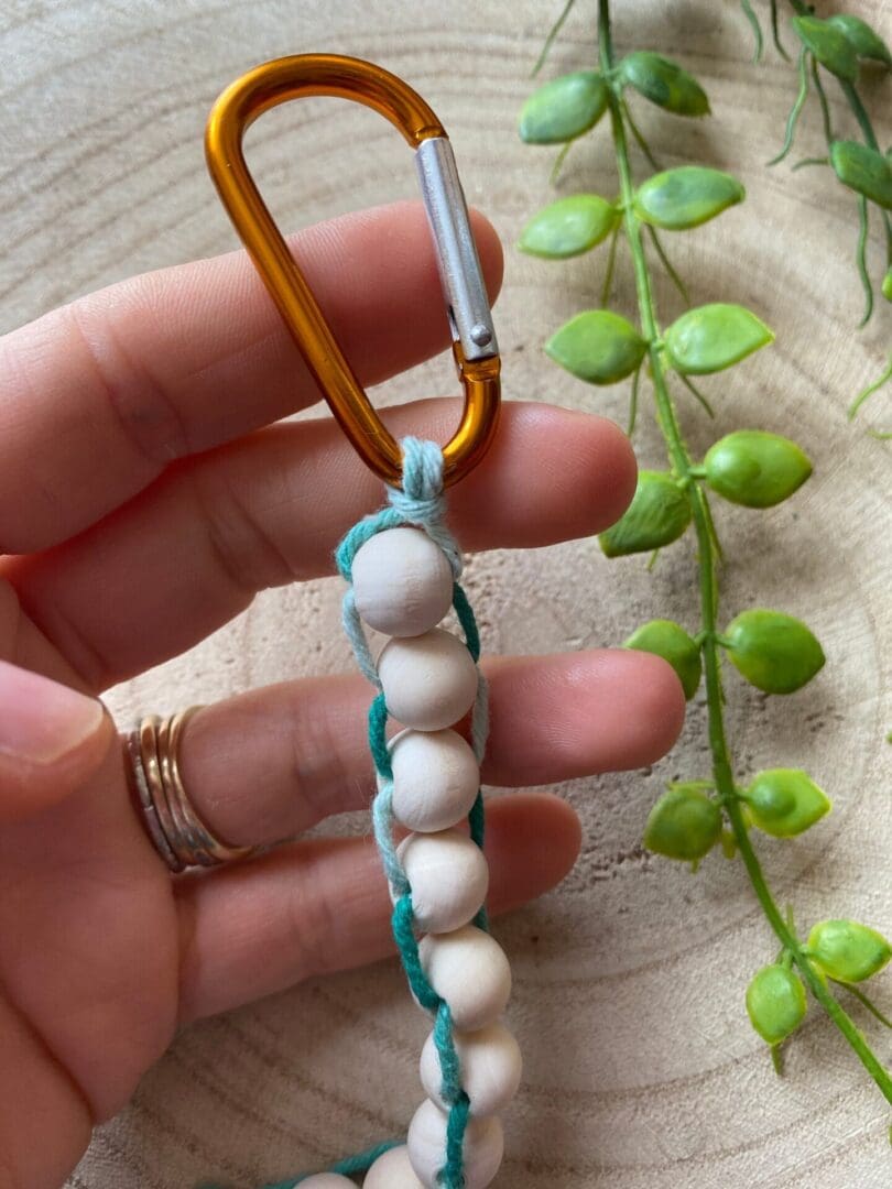 Golf Stroke counter made with recycled cotton, and wooden beads on a carabiner clip