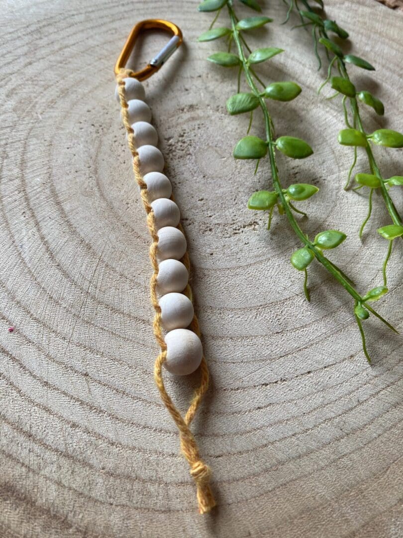 Golf Stroke counter made with recycled cotton, and wooden beads on a carabiner clip