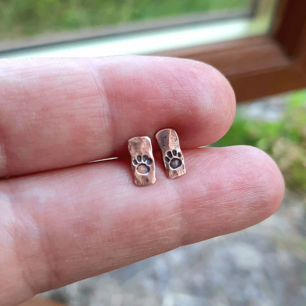 Hammered copper paw print stud earrings, handmade by The Tiny tree Frog Jewellery