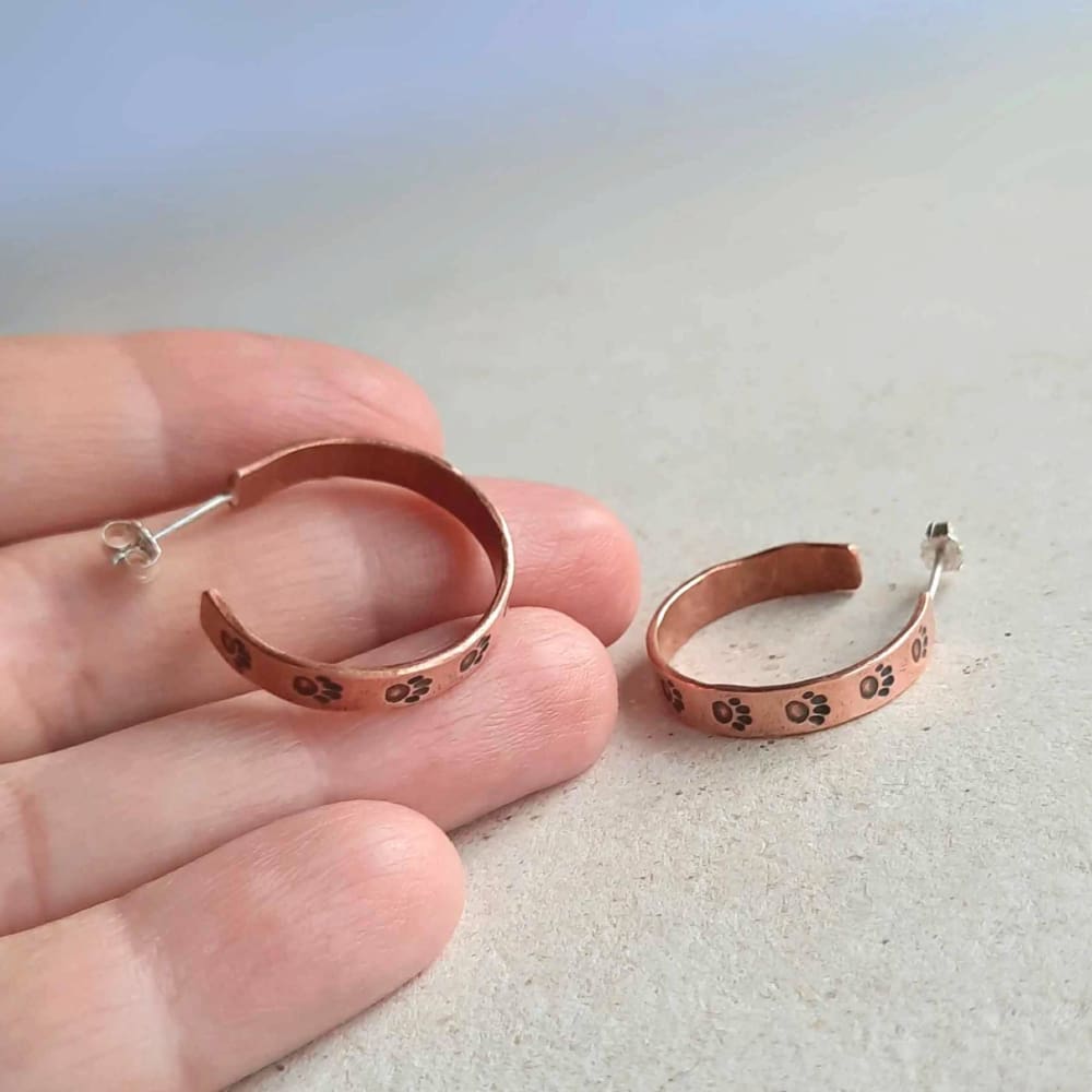 Copper paw print half hoop earrings, handmade by The Tiny Tree Frog Jewellery