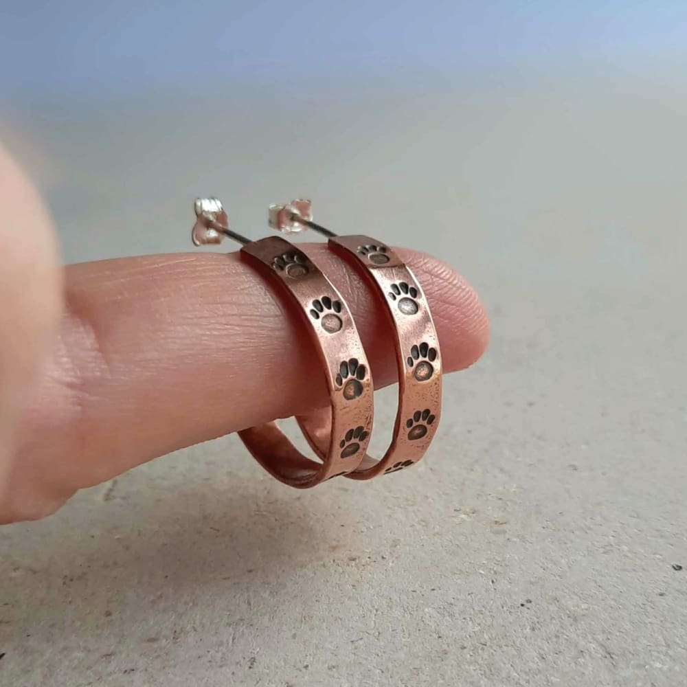 Handstamped copper paw print open hoop earrings, handcrafted by The Tiny Tree Frog Jewellery