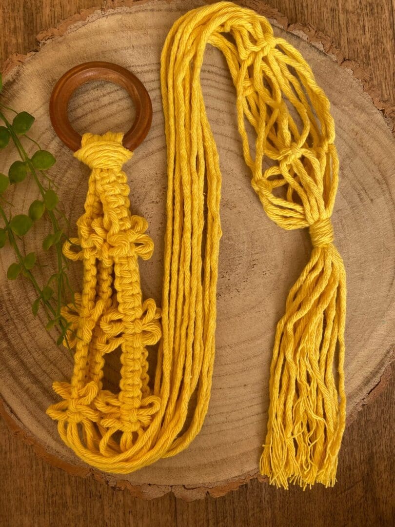 Yellow macrame plant hanger made with recycled cotton.