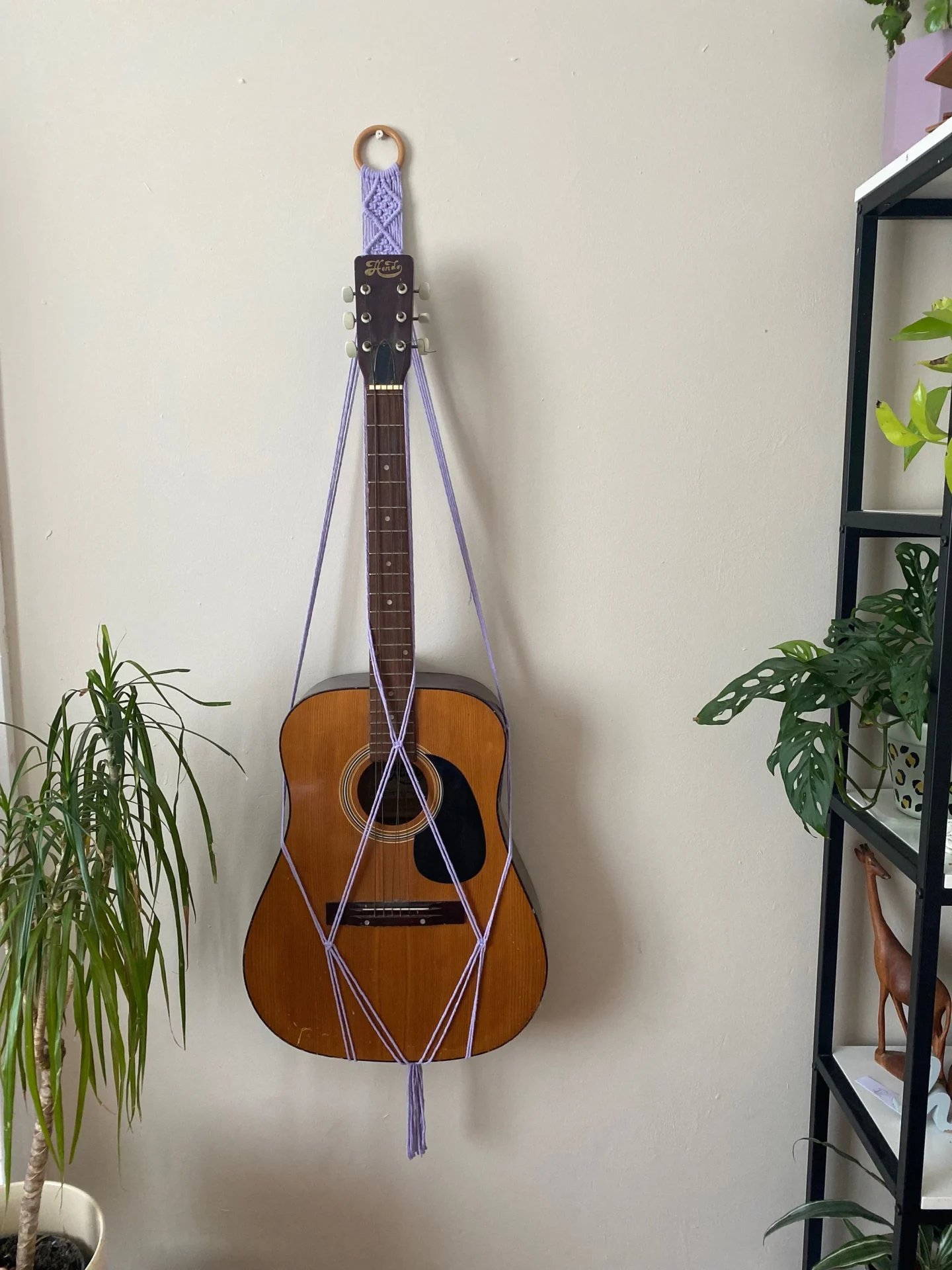 Wall hanging acoustic guitar holder, made with recycled cotton.