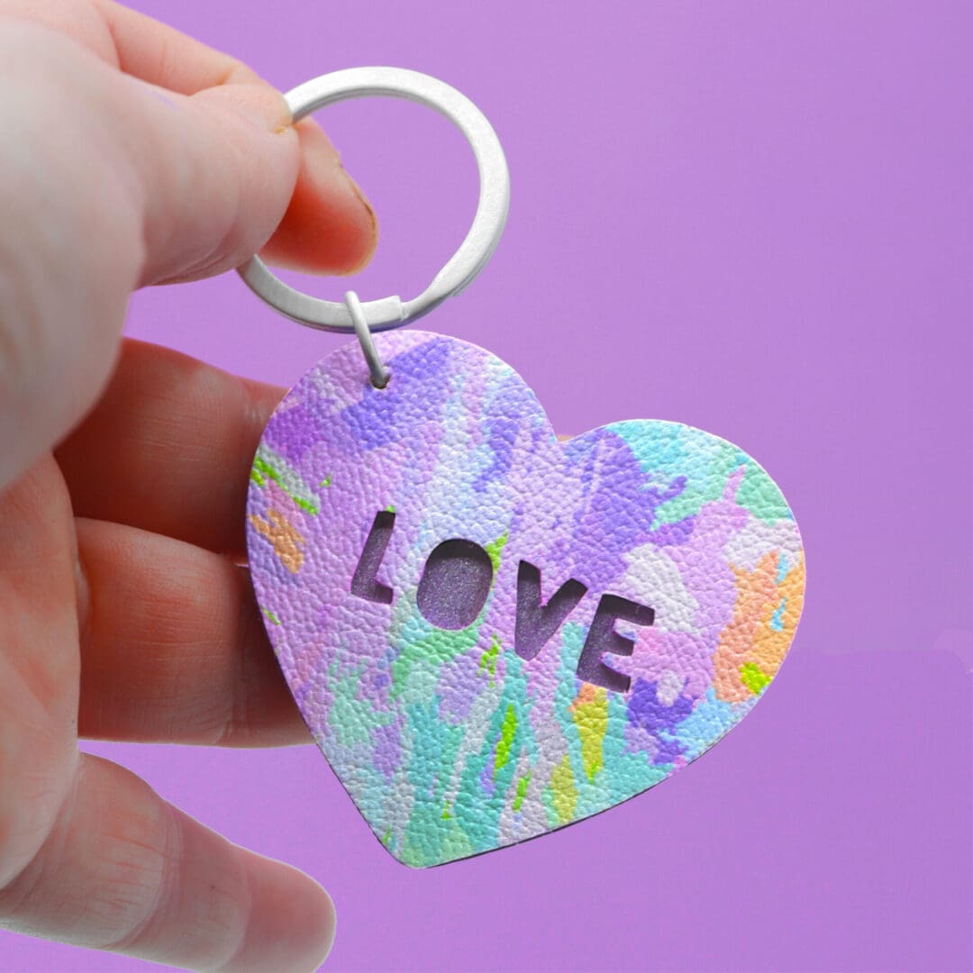 Pretty painterly faux leather keyring. Pastel rainbow colours. True cut out on one side, Love cut out on the other