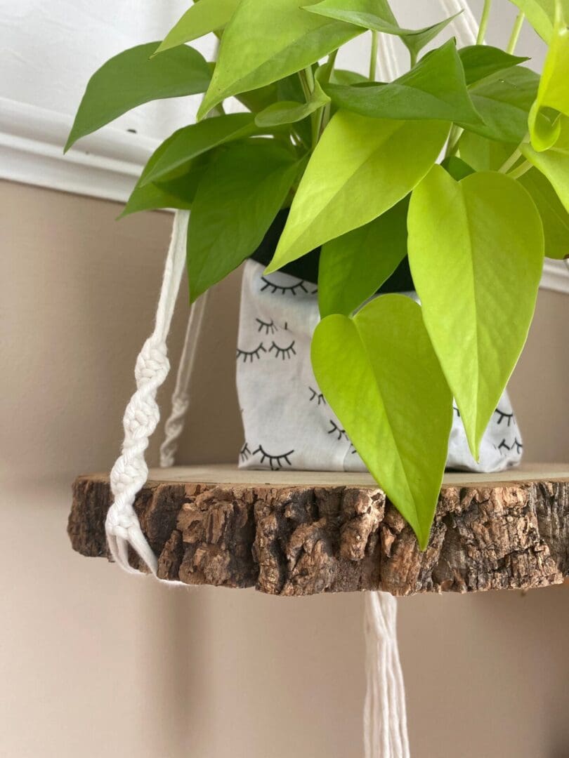 Macrame hanging shelf made with natural wood slice and recycled cotton yarn