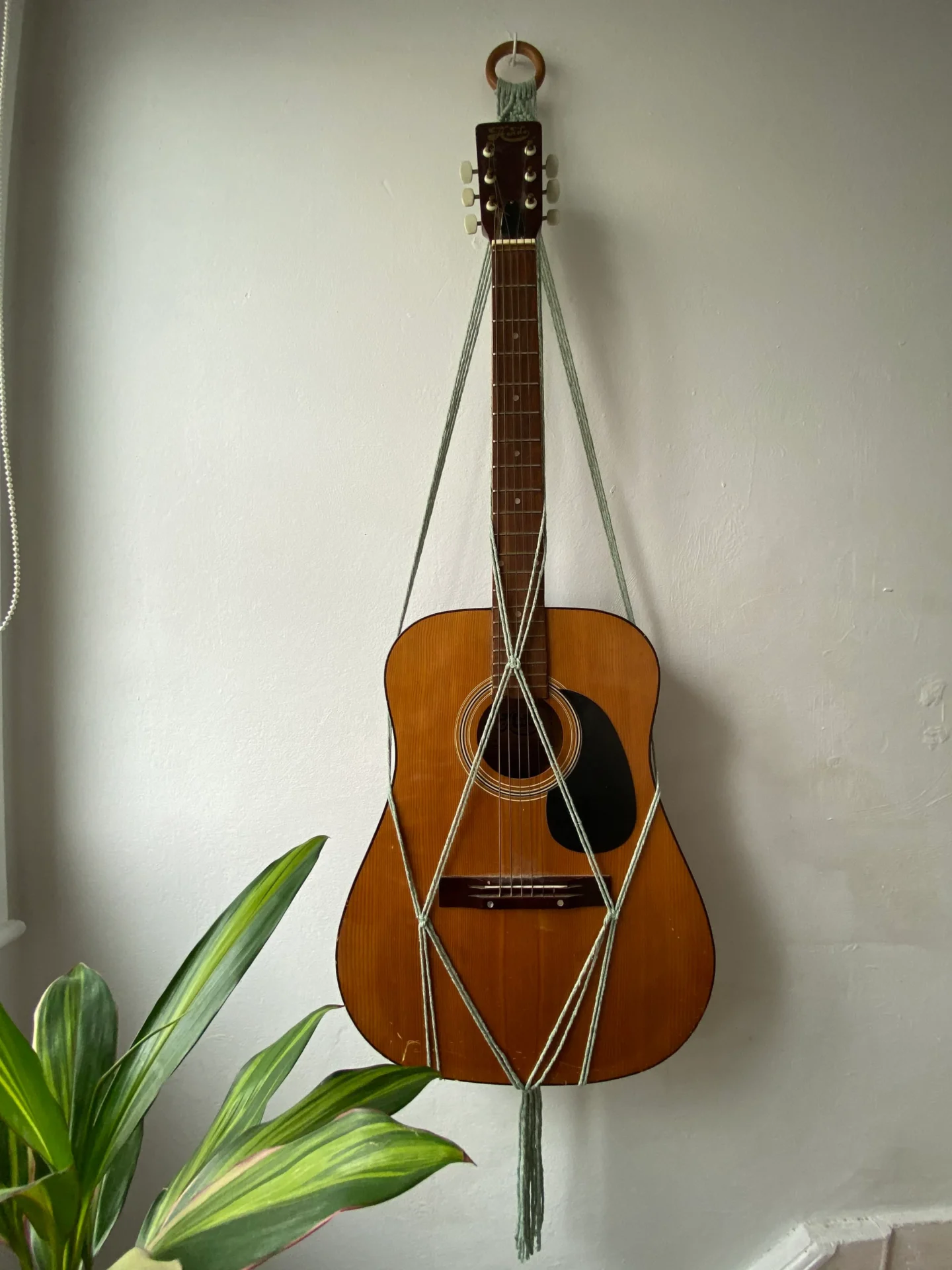 Wall hanging acoustic guitar holder, made with recycled cotton.