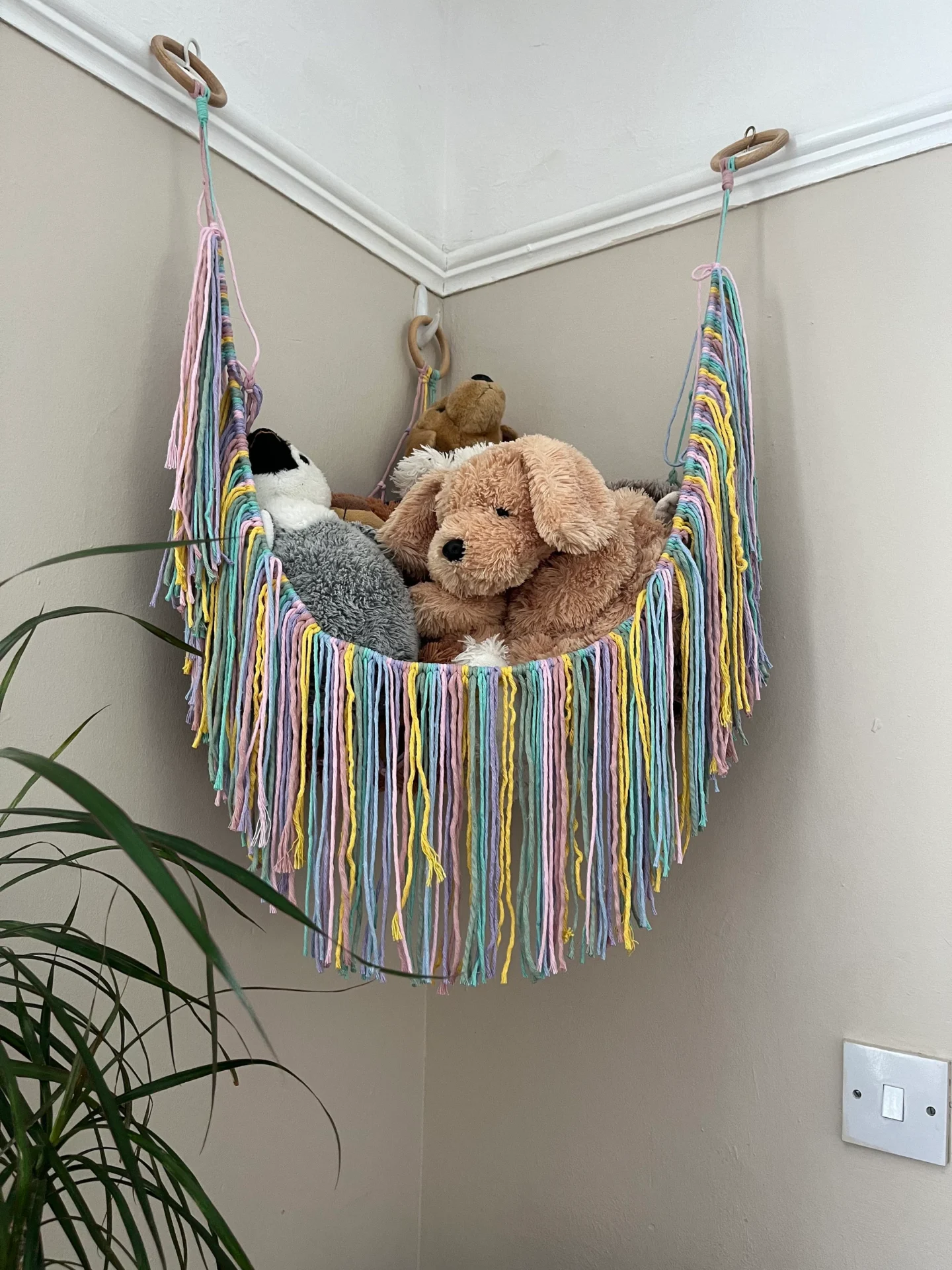 Soft toy storage corner hammock, made with recycled cotton.