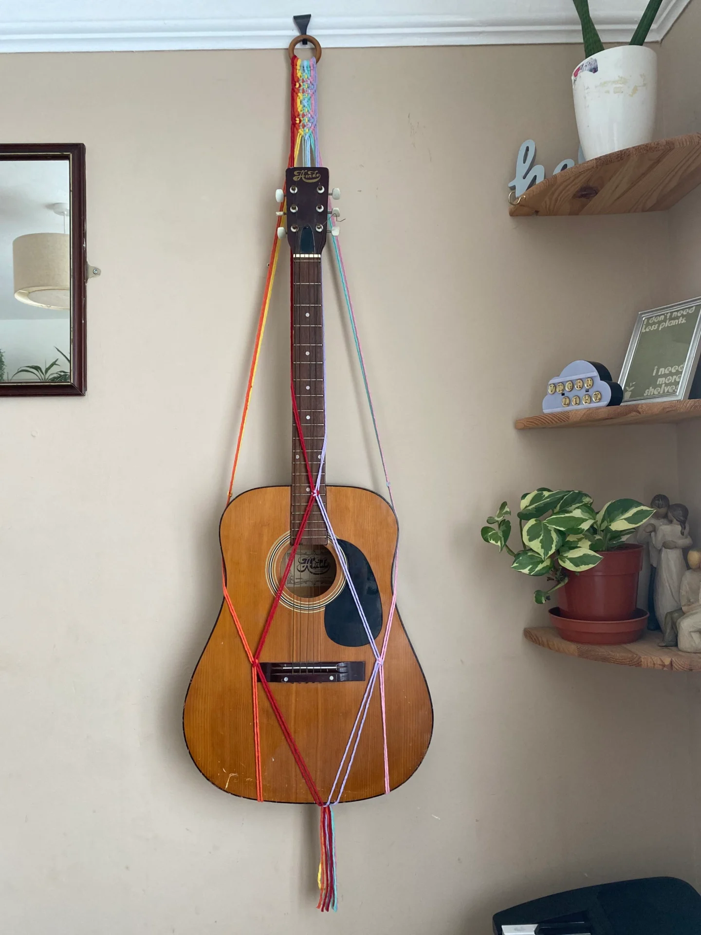 Wall hanging acoustic guitar holder, made with recycled cotton.