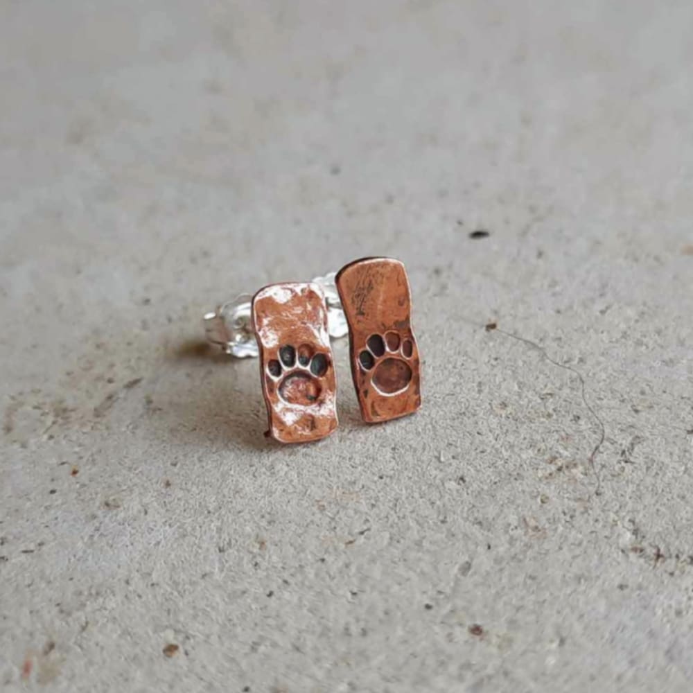 Rustic boho style copper paw print stud earrings, hand made by The Tiny Tree Frog Jewellery