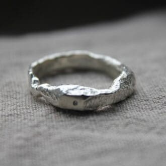 organic textured sand cast ring with flush set tiny cz