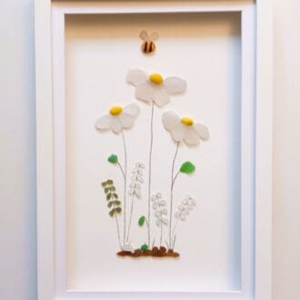 picture of flowers made from tiny nuggets of cornish sea glass set in a large frame