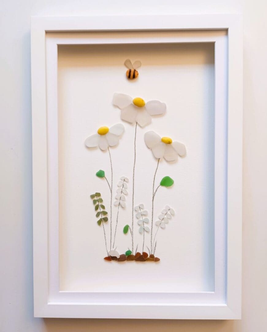 picture of flowers made from tiny nuggets of cornish sea glass set in a large frame