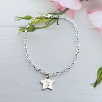 sterling silver oval link chain bracelet with a star charm personalised with a handstamped initial