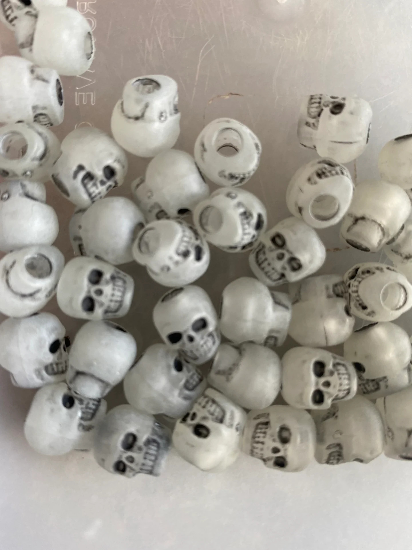 Pile of plastic skull shaped beads