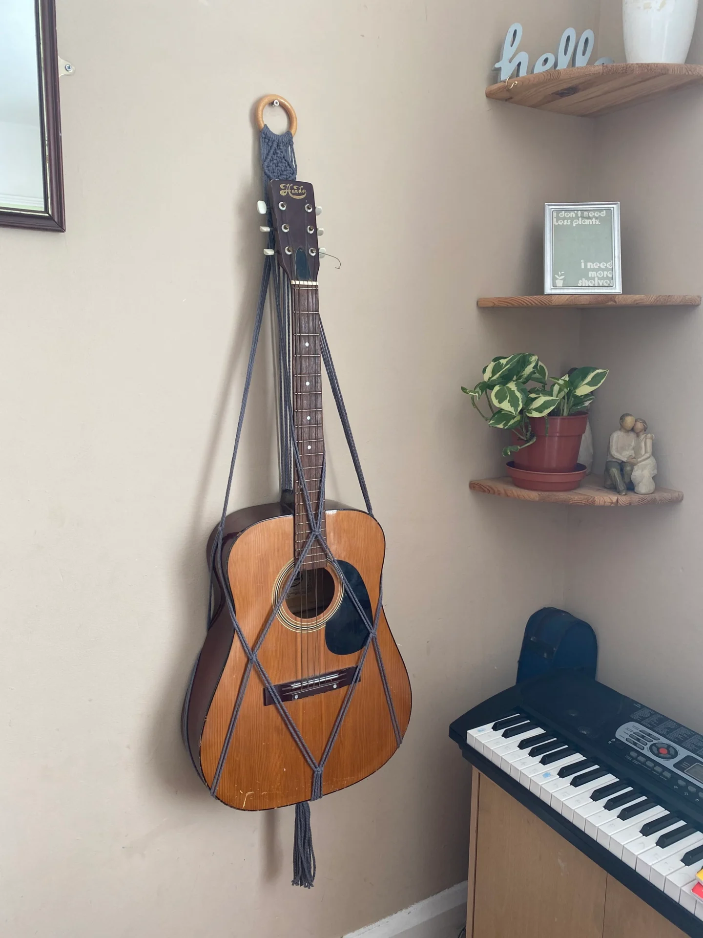 Wall hanging acoustic guitar holder, made with recycled cotton.