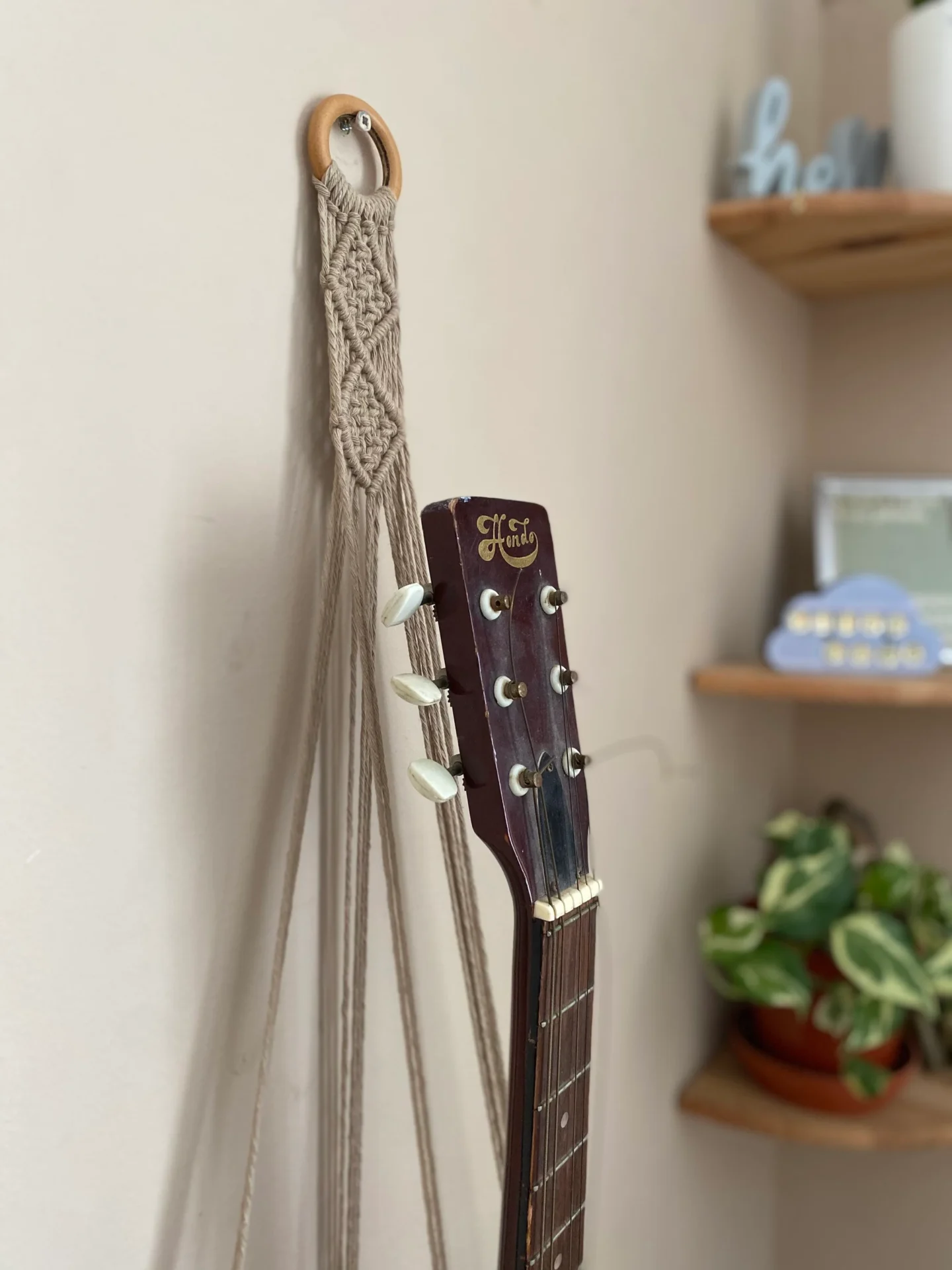 Wall hanging acoustic guitar holder, made with recycled cotton.