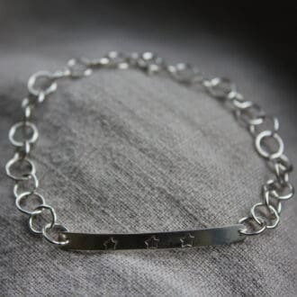 dainty silver bracelet. circle chain with bar stamped with 3 stars