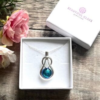 Sparkly turquoise blue dichroic glass knot pendant