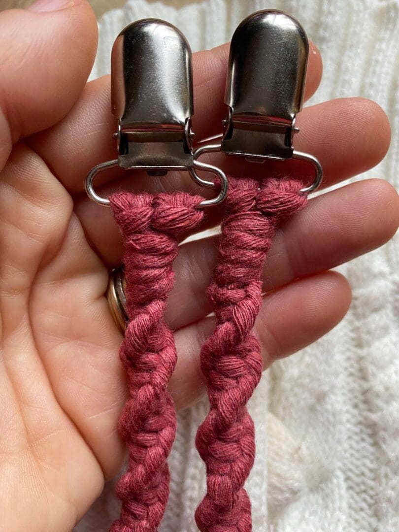 A pair of wild rose mitten clips made with recycled cotton