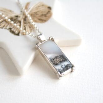 Rectangular dendritic opal gemstone necklace with a tree cut-out on the back