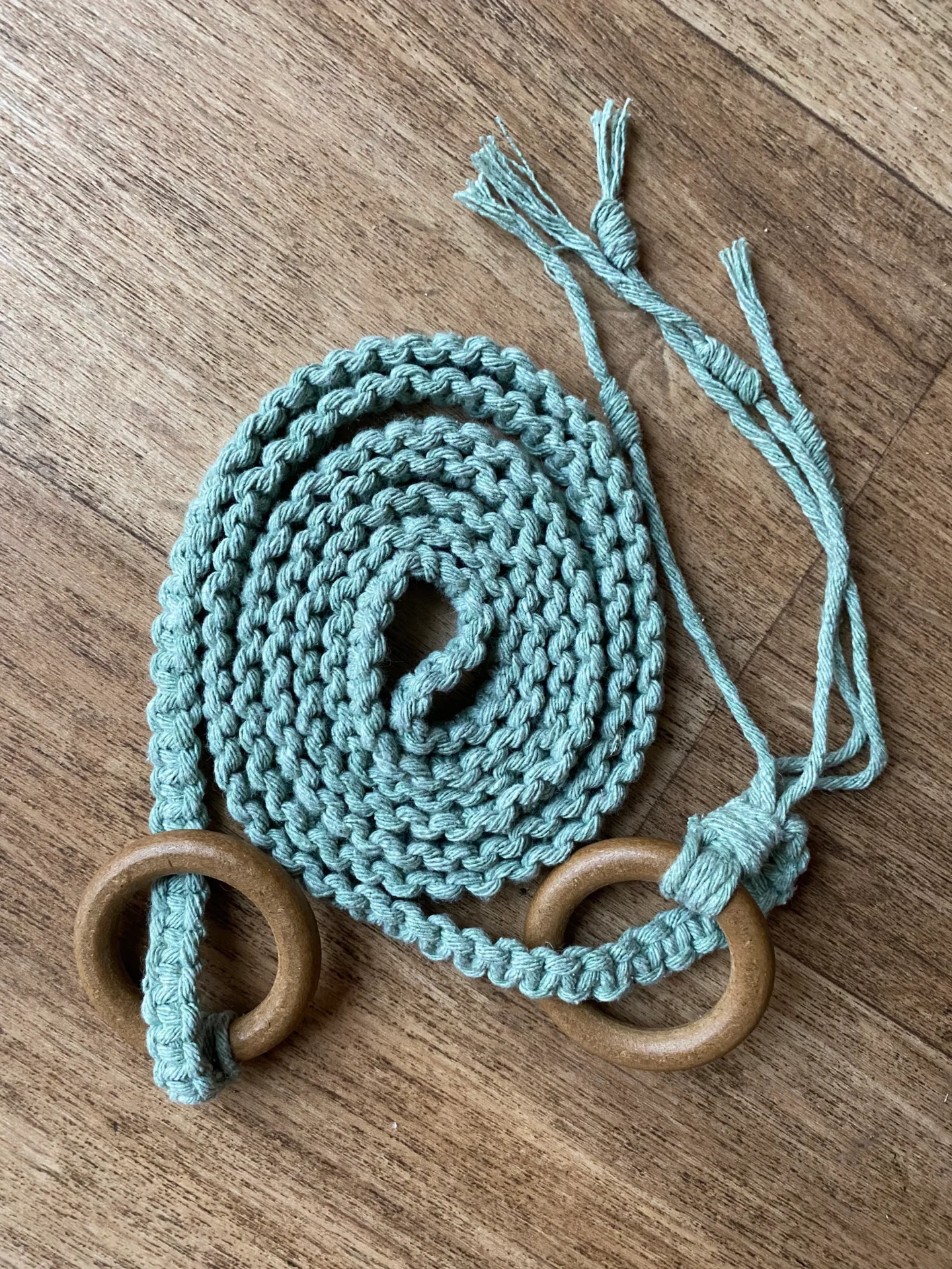 Macrame yoga mat strap, handmade using recycled yarn and repurposed wooden rings.