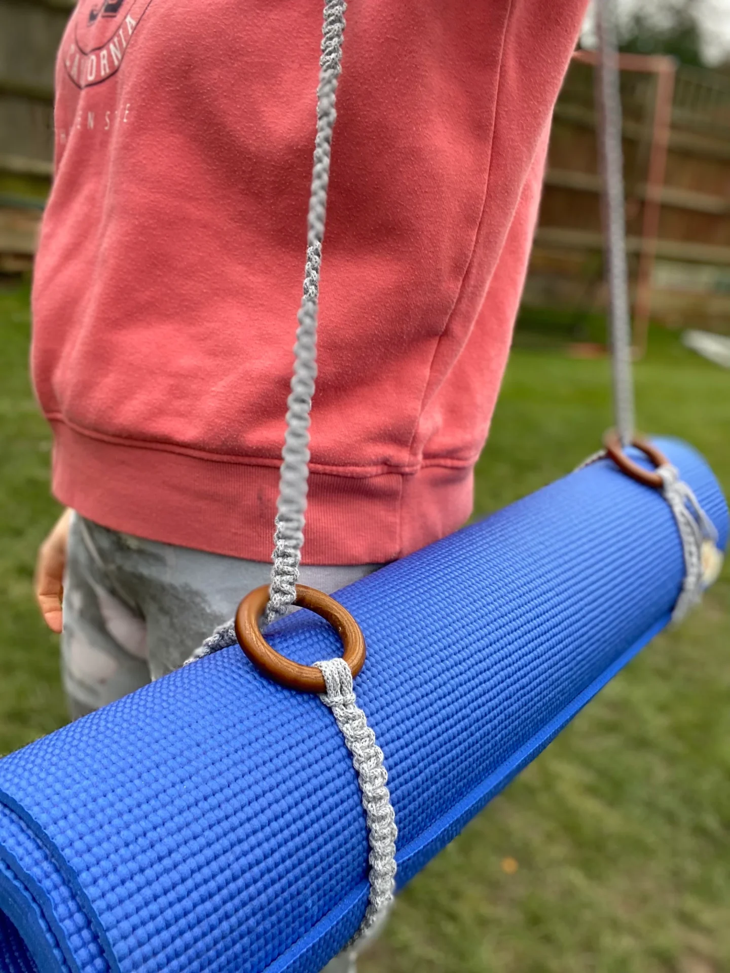 Macrame yoga mat strap, handmade using recycled yarn and repurposed wooden rings.