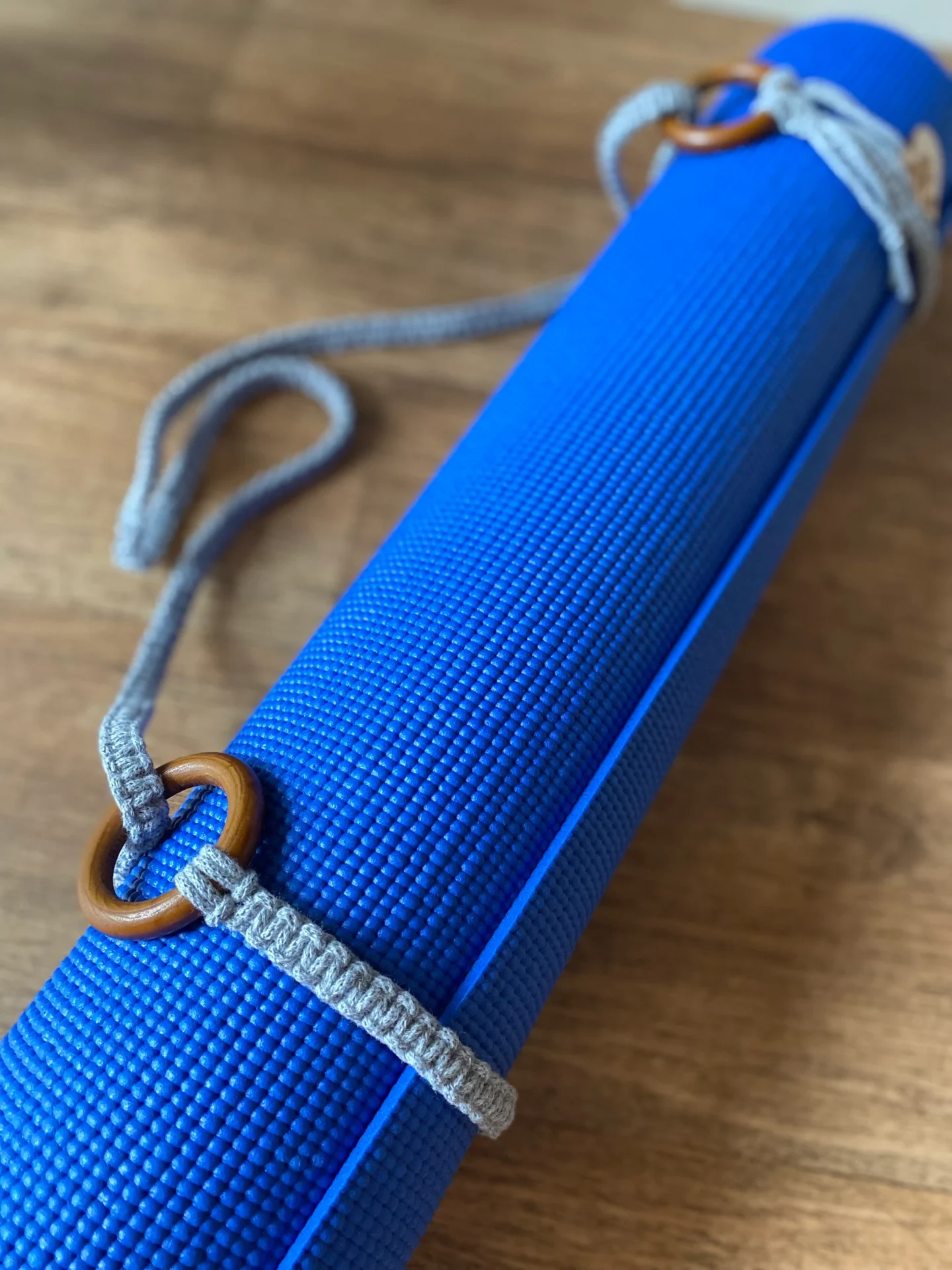 Macrame yoga mat strap, handmade using recycled yarn and repurposed wooden rings.