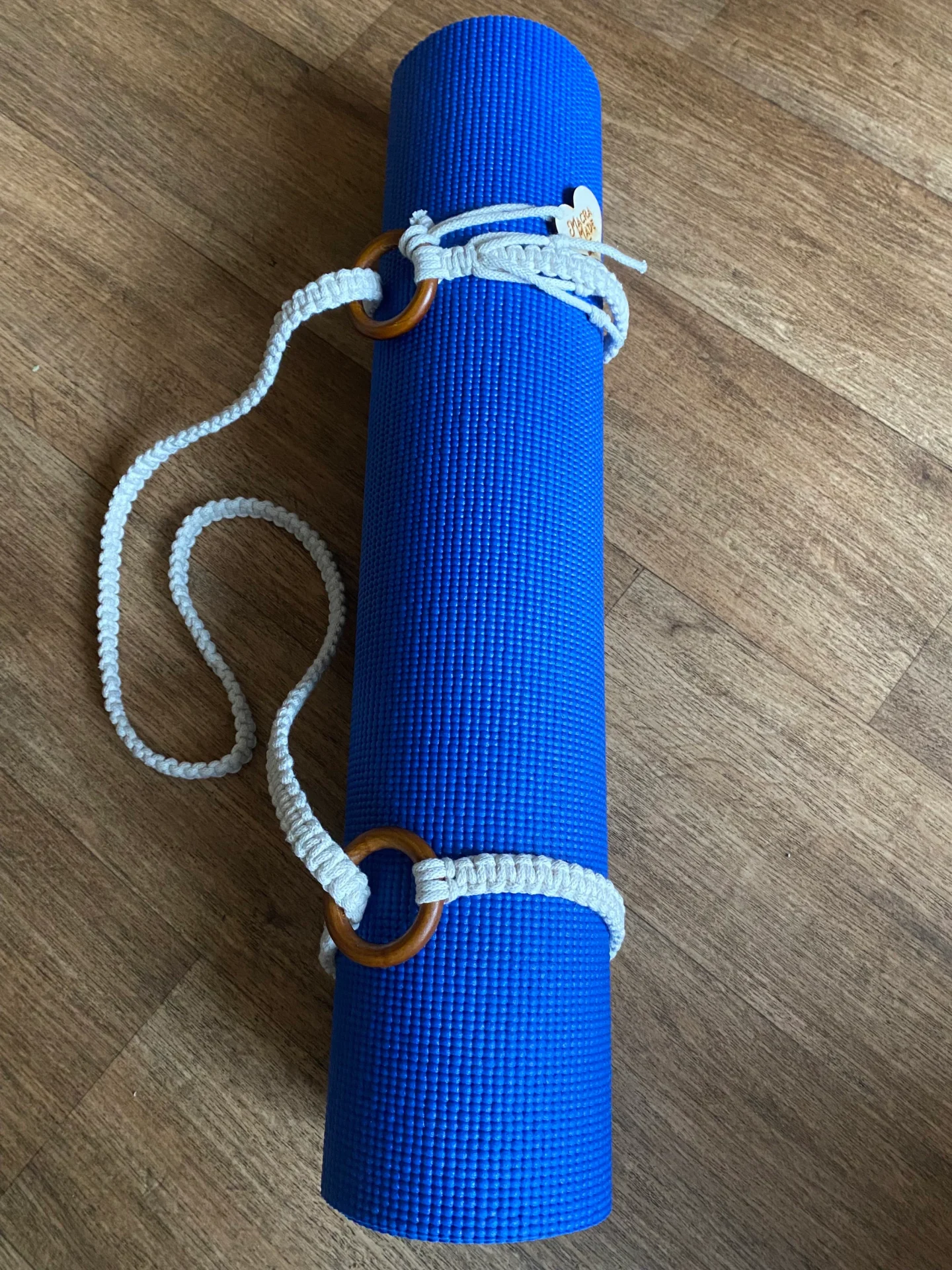 Macrame yoga mat strap, handmade using recycled yarn and repurposed wooden rings.