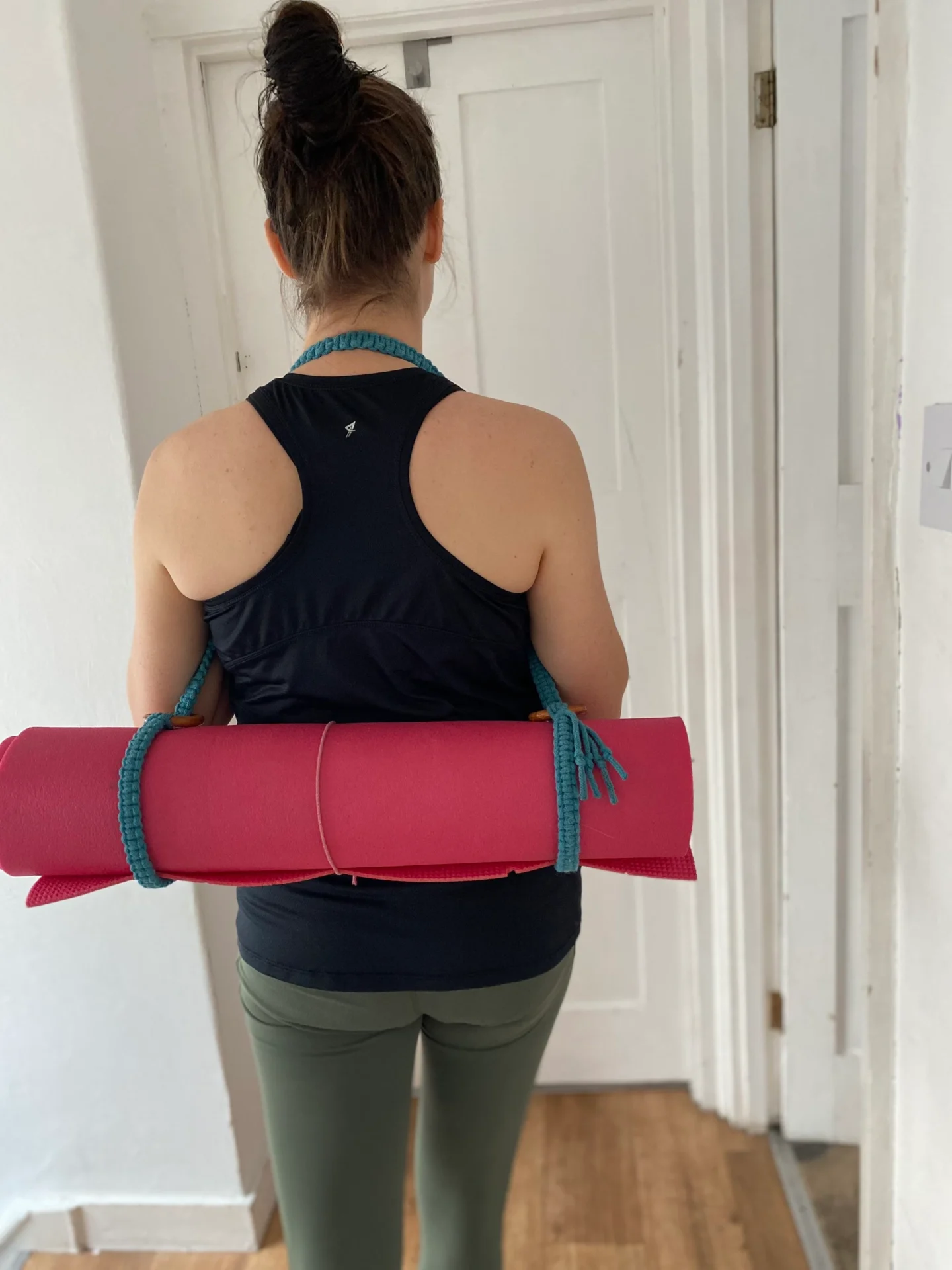 Macrame yoga mat strap, handmade using recycled yarn and repurposed wooden rings.