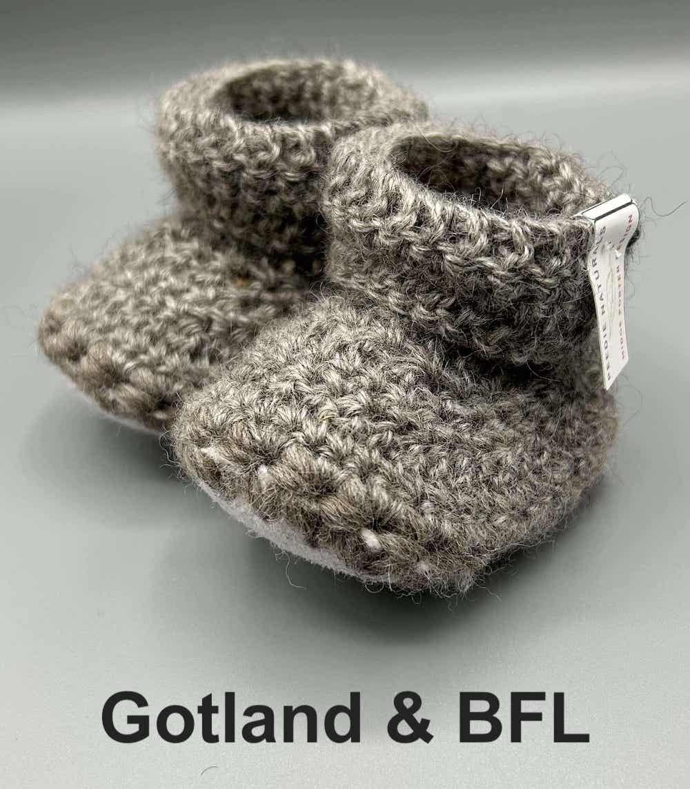 Pair of light grey baby booties crocheted with a sheepskin sole in natural colour Gotland and Blue Faced Leicester wool by Midge Porter Design