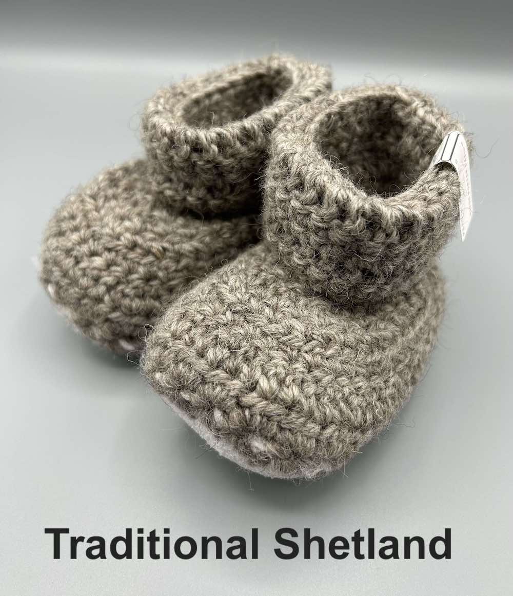 Pair of light grey baby booties crocheted with a sheepskin sole in traditional coloured real Shetland wool by Midge Porter Design