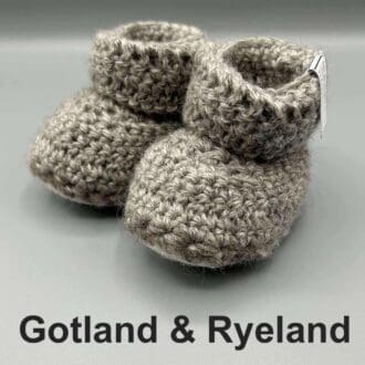 Pair of light grey baby booties crocheted with a sheepskin sole in natural colour Gotland and Ryeland wool by Midge Porter Design