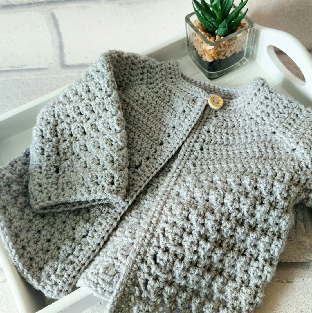 Handmade crochet baby cardigan made from soft yarn, perfect for newborns and toddlers. Ideal as a baby shower gift or keepsake, crafted with love in the UK Includeithd various colours and sizes available