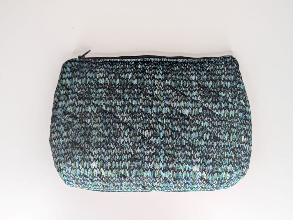 Versatile small bag for makeup or travel essentials, crafted from woven fabric