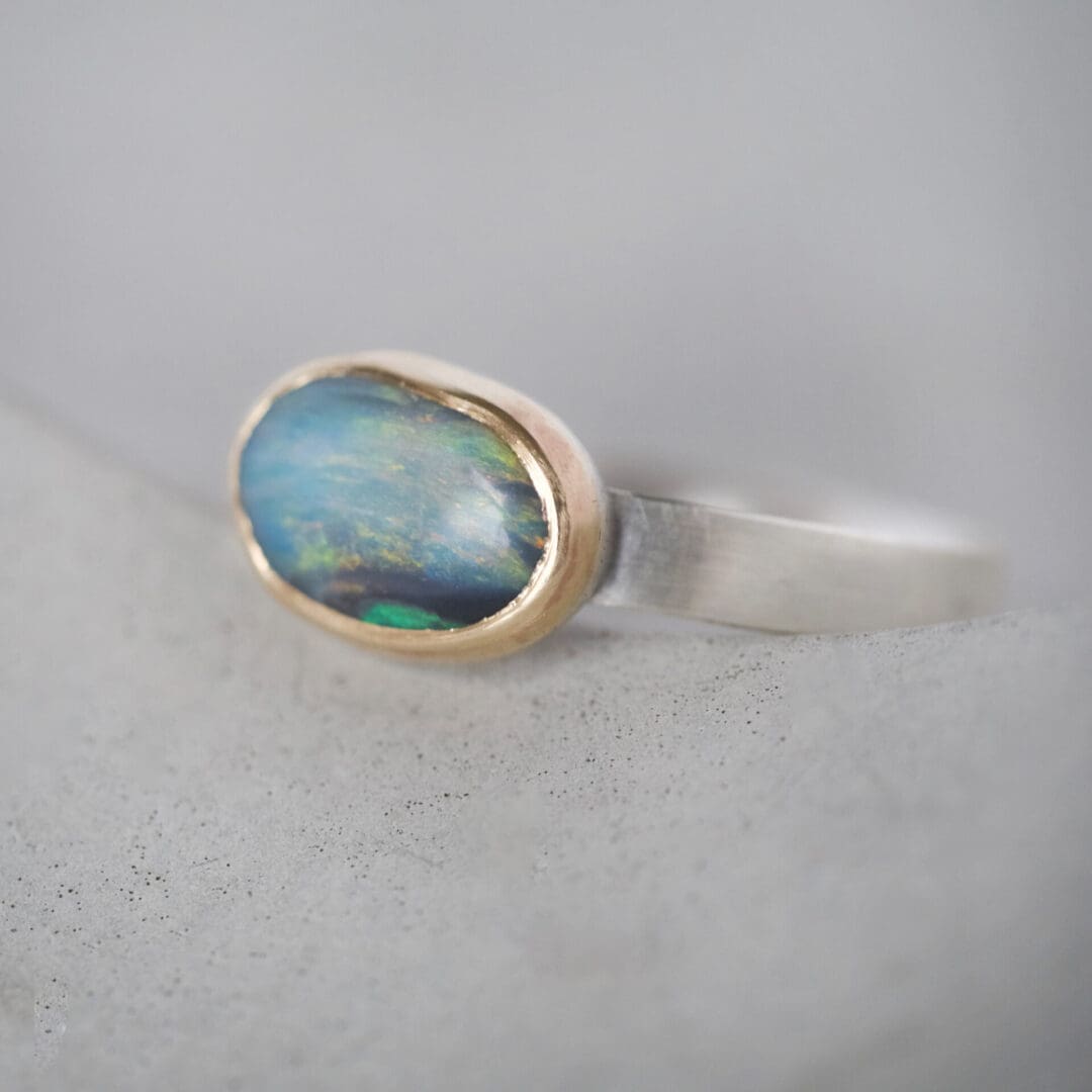 Australian boulder opal ring with 9ct yellow gold bezel and sterling silver