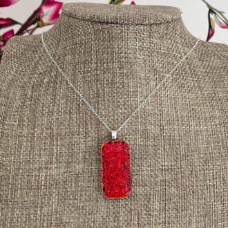 Bright volcanic red sparkly dichroic glass pendant on a sterling silver chain