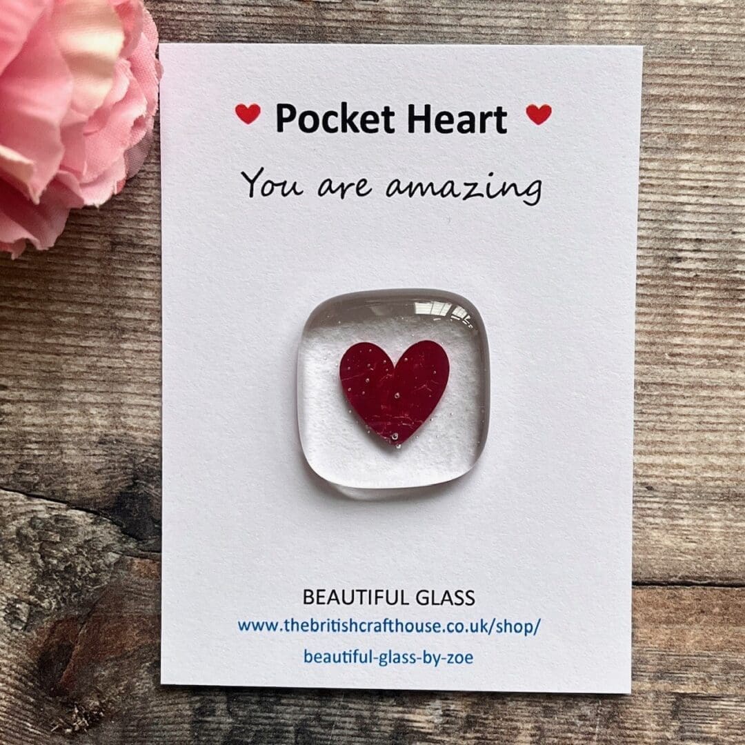 Clear fused glass pocket hug with a pretty pink heart