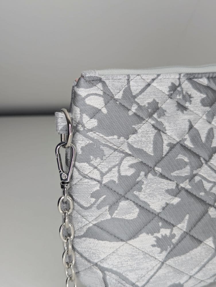 Small silver handbag featuring a floral texture and lightweight chain