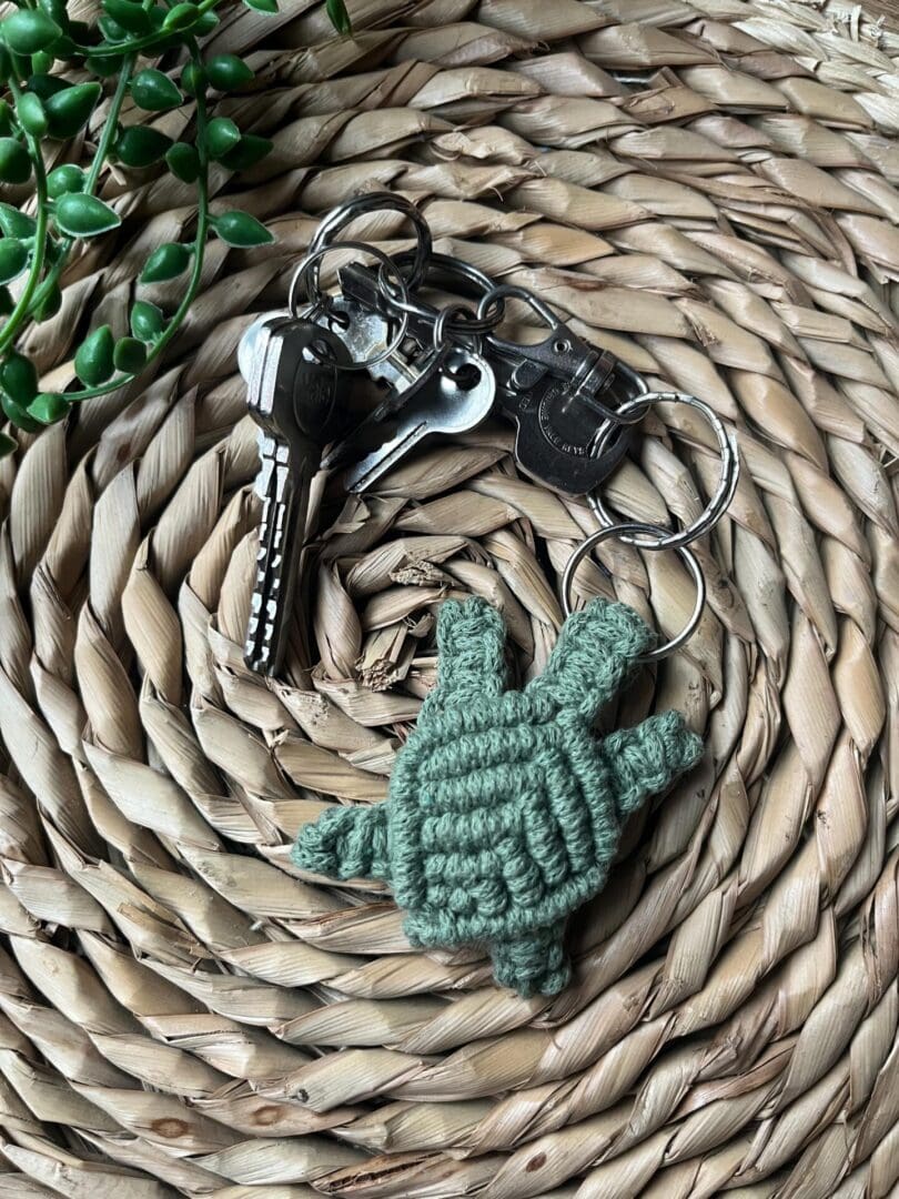 Handmade macrame turtle keyring, made with green recycled cotton yarn