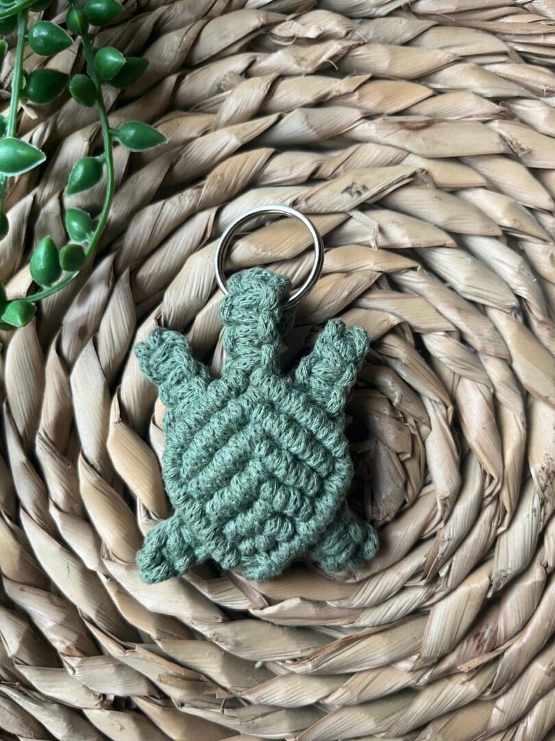 Handmade macrame turtle keyring, made with green recycled cotton yarn