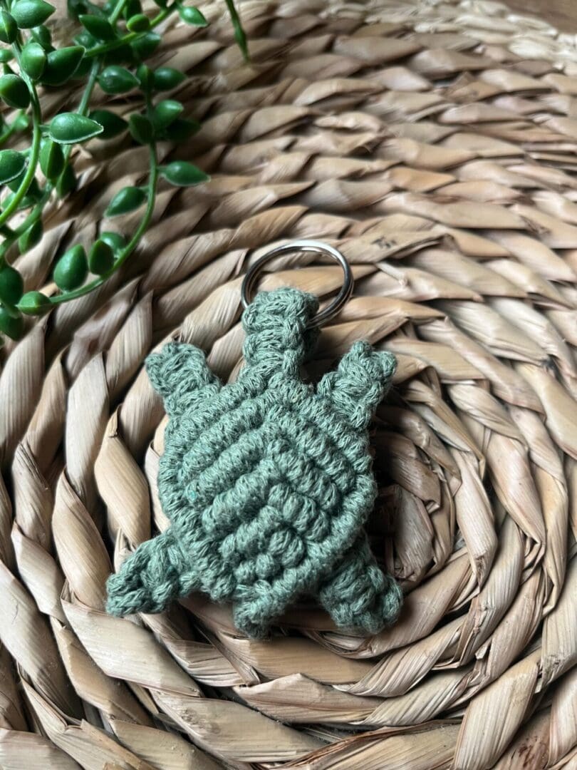 Handmade macrame turtle keyring, made with green recycled cotton yarn