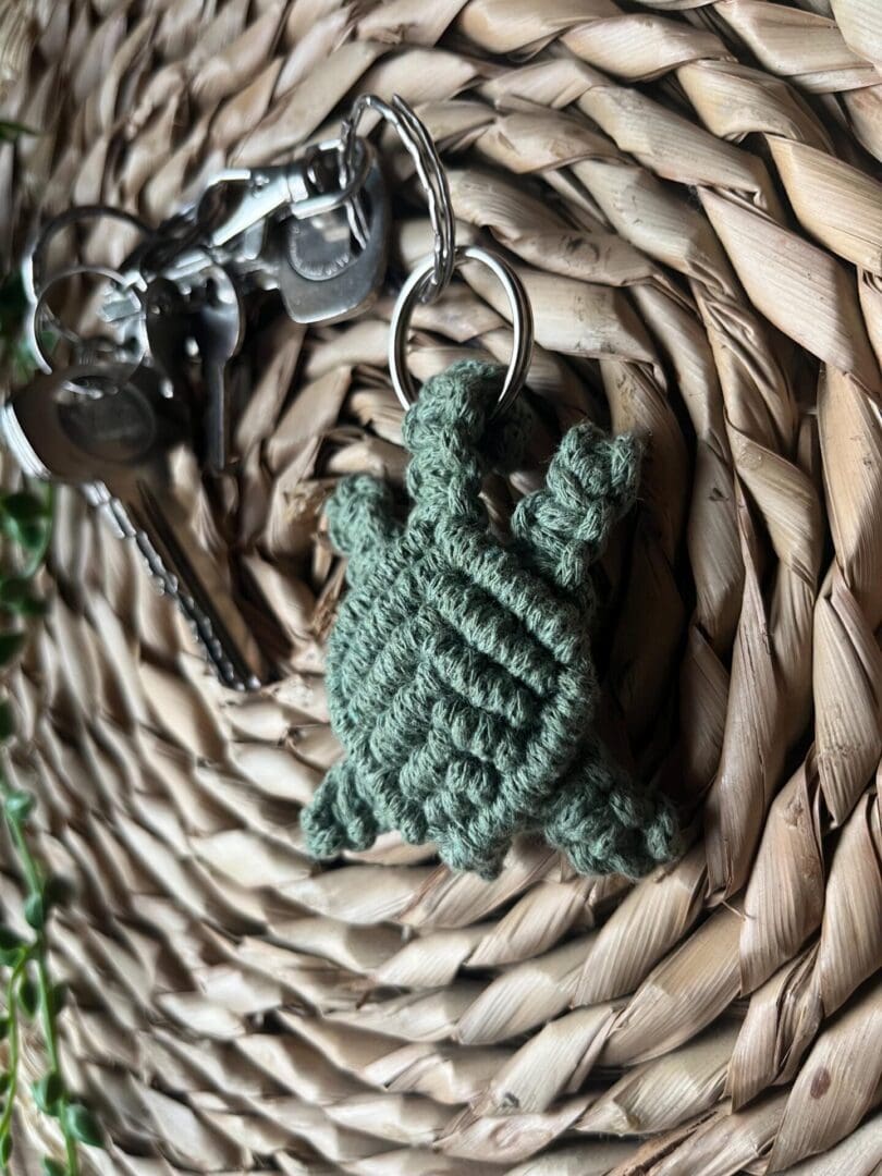 Handmade macrame turtle keyring, made with green recycled cotton yarn