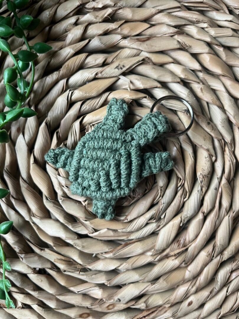 Handmade macrame turtle keyring, made with green recycled cotton yarn