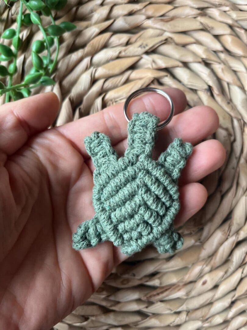 Handmade macrame turtle keyring, made with green recycled cotton yarn